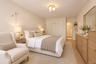 Neutral-toned interior featuring wood-finish flooring, a contemporary multi-globe ceiling light, and double-door reach-in closet
