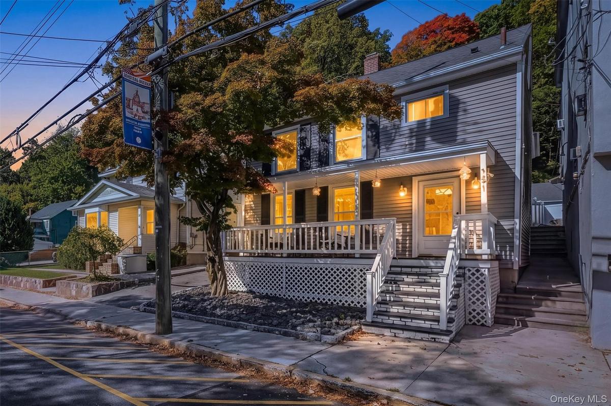 Stunning twilight exterior view of the front porch colonial, highlighting the warm lighting and inviting curb appeal.