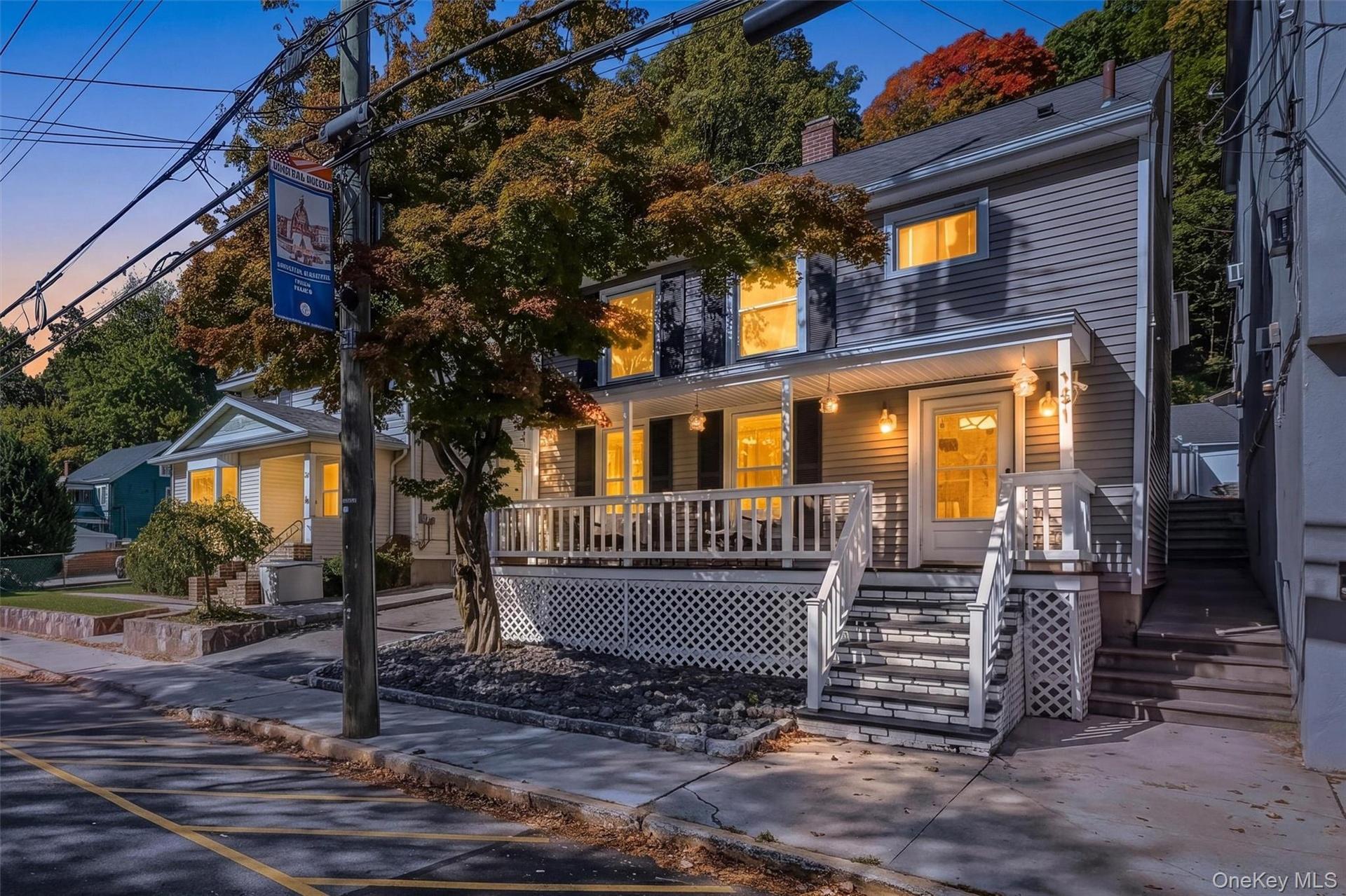 Stunning twilight exterior view of the front porch colonial, highlighting the warm lighting and inviting curb appeal.