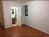 Unfurnished bedroom featuring dark wood-style floors and ensuite bath
