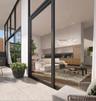 Floor-to-ceiling glass wall panels with black framing, wood-finish flooring, custom wood-veneer cabinetry, recessed ceiling lighting, and sculptural L