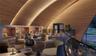 Curved wood-paneled ceiling, integrated recessed accent lighting, built-in recessed wall niches, dark wood-finish flooring, and expansive floor-to-cei