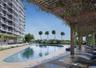 Swimming pool with stone surround, extensive wood-finish pergola, and integrated exterior lighting