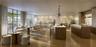 Open-concept space featuring floor-to-ceiling windows, wood-finish flooring, two expansive kitchen islands with stone countertops, and recessed lighti