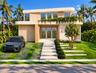 Modern two-story architectural exterior featuring smooth stucco cladding, natural wood-finish siding, integrated second-story greenery, floor-to-ceili
