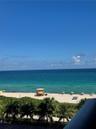 Direct oceanfront exposure with panoramic water scenery, sandy beach access, and lush palm foliage