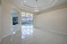 Interior space featuring tile flooring, a recessed tray ceiling, architectural archway, and expansive sliding glass doors opening to a screened pool e
