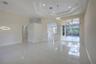 Open interior featuring a tray ceiling, recessed lighting, modern geometric pendant light fixtures, light-toned tile flooring, and floor-to-ceiling gl