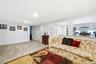 Open-concept interior featuring wood-finish flooring, recessed lighting, and a kitchen pass-through with a solid surface breakfast bar