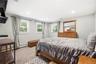 Neutral-toned interior featuring recessed lighting, carpeted flooring, and three dual-pane windows with integrated hardware