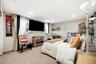 Neutral-toned interior featuring wall-to-wall carpeting, recessed ceiling lighting, and built-in floating wall shelving