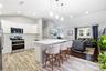 Kitchen featuring white cabinetry, a center island with a quartz countertop, stainless steel appliances, a white subway tile backsplash, and wood-fini