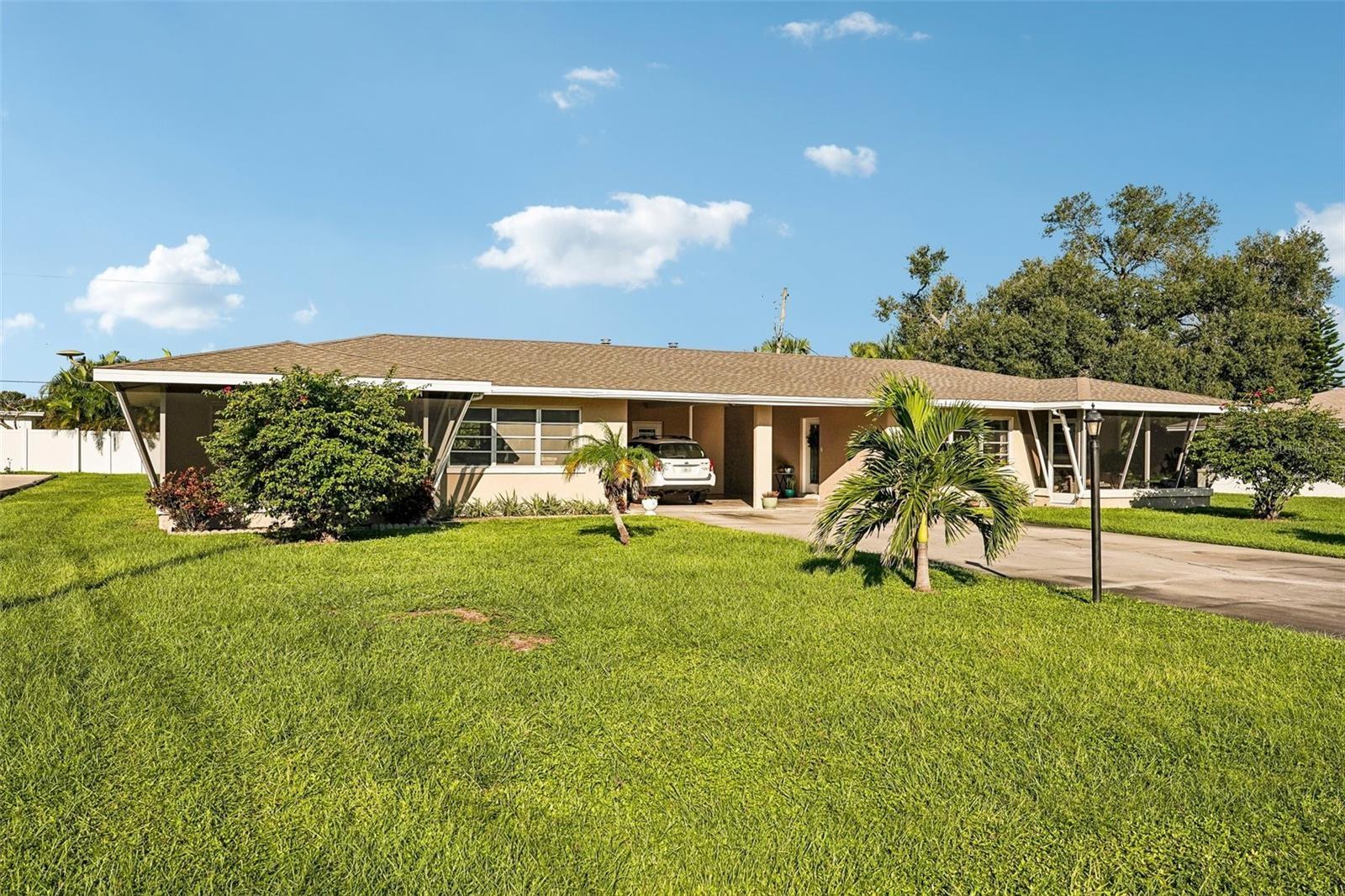 Duplex - 309 on left, 311 on right - oversized lot, covered parking for two cars, private screened lanai for each