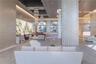 Grand lobby featuring a high-contrast coffered ceiling, tiered crystal chandeliers, stone-clad structural columns, arched windows, and large-scale bac
