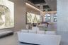 Grand foyer featuring high ceilings with recessed lighting, tiered crystal chandeliers, large-format mural wall installations, arched windows, and her