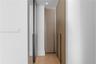 Custom built-in cabinetry with textured, diagonal-patterned detailing, full-length dark metallic hardware, integrated recessed lighting, and wood-fini