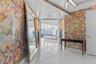Entryway featuring large-scale butterfly pattern wallcoverings, high-gloss tile flooring, integrated linear lighting, and wall-mounted sconces