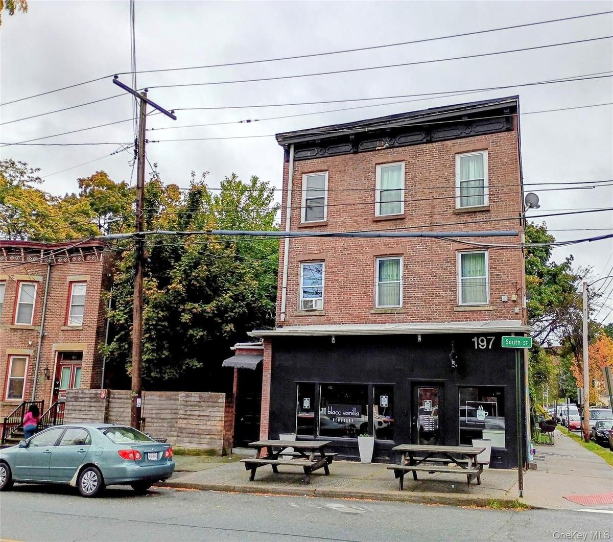 FRONT VIEW OF LOT AT 195 SOUTH STREET BEHIND WOODEN FENCE AND 197 SOUTH STREET / BLACC VANILLA COFFEE SHOP.
