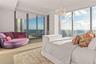 Floor-to-ceiling glass windows, recessed display shelving, wood-finish flooring, integrated ceiling light fixture, and sliding glass doors opening to 