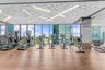 Fitness center featuring wood-finish flooring, floor-to-ceiling windows, and a geometric textured ceiling with integrated linear lighting