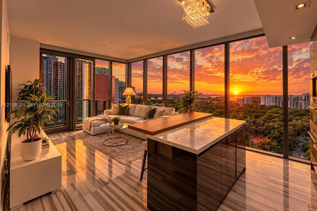 Floor-to-ceiling glass walls with sunset backdrop, kitchen island with stone-finish countertop and wood-finish cabinetry, linear stone-finish flooring