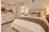 Neutral-toned interior featuring stone-finish flooring and recessed ceiling lighting