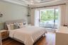 Tray ceiling with crown molding, wood-finish flooring, dual metal-and-crystal chandeliers, and sliding glass doors
