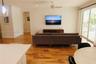 Living area featuring wood-finish flooring, ceiling-mounted paddle fan, recessed lighting, and expansive glass sliding doors