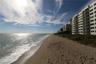 Coastal high-rise building with balcony access and direct shoreline frontage
