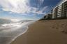 Sandy beachfront coastline featuring direct shoreline access and exterior balconies