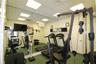 Full-wall mirrored accent, drop ceiling with recessed lighting, and wall-mounted door hardware