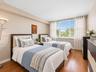 Wood-finish flooring and a large, multi-panel window allowing natural light