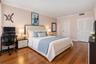 Wood-finish flooring, crown molding, and dual louvered closet doors