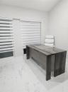 Polished white tile flooring with grey veining, dual windows, and adjustable horizontal window shades
