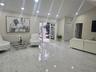 Vaulted ceilings, large-format stone-finish flooring, recessed lighting, and a glass-panel entry door