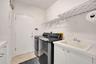 Large laundry room with lots of cabinetry and sink