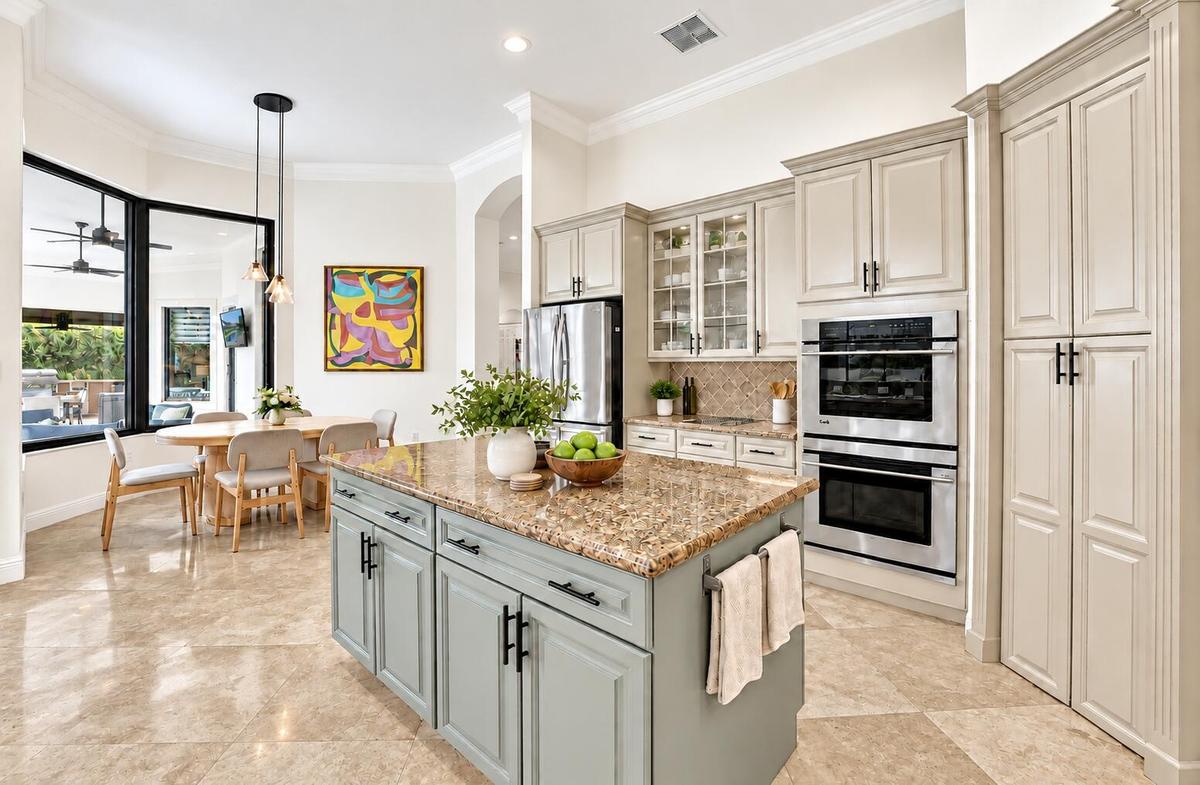 Kitchen island, double ovens and walk-in pantry