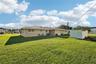 Back of duplex, shared laundry / utility room in center, plus two storage sheds. Oversized lot with a third of an acre!