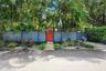 Solid-panel privacy fencing, gated pedestrian entry, concrete paver walkway, and mature landscaping