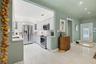 Kitchen featuring white shaker-style cabinetry, stainless steel appliances, recessed lighting, and tile flooring throughout