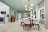 Open-concept living space featuring high-gloss tile flooring, recessed lighting, a modern multi-globe chandelier, and a kitchen equipped with white ca