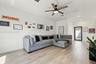 Open-concept interior featuring light wood-finish flooring, recessed lighting, and a modern ceiling fan with integrated lighting