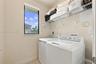 Laundry area featuring a window, built-in wire shelving, and appliance hookups
