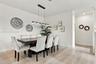 Neutral wall color palette, light-toned wood-finish flooring, and a linear multi-light pendant fixture