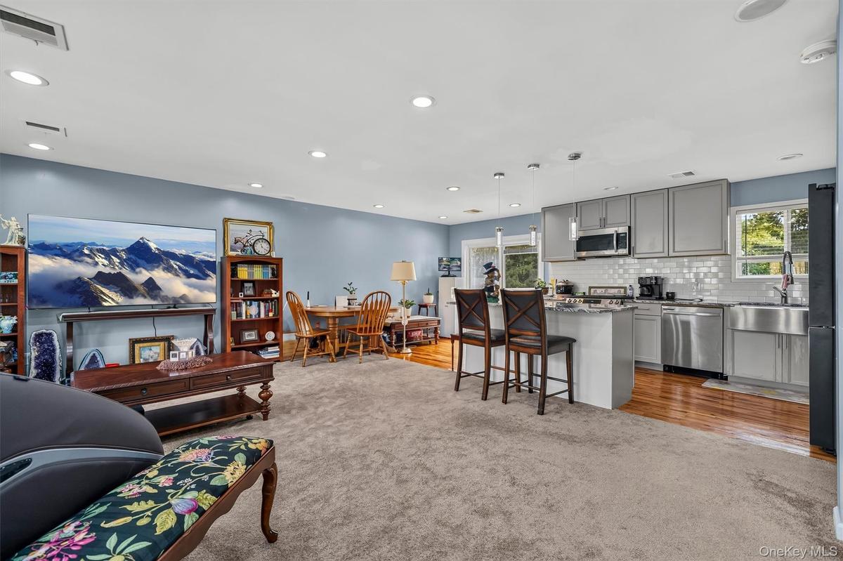Open floor plan.  Hardwood under carpet.  Carpet not glued down.