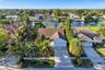 Neighborhood aerial. Pools and docks shown are on neighboring properties and are not included with this rental. Inland canal with fixed bridges and no