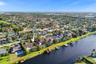 Neighborhood aerial. Pools and docks shown are on neighboring properties and are not included with this rental. Inland canal with fixed bridges and no