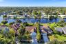Neighborhood aerial. Pools and docks shown are on neighboring properties and are not included with this rental. Inland canal with fixed bridges and no