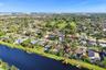 Neighborhood aerial. Pools and docks shown are on neighboring properties and are not included with this rental. Inland canal with fixed bridges and no