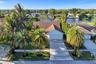 Neighborhood aerial. Pools and docks shown are on neighboring properties and are not included with this rental. Inland canal with fixed bridges and no